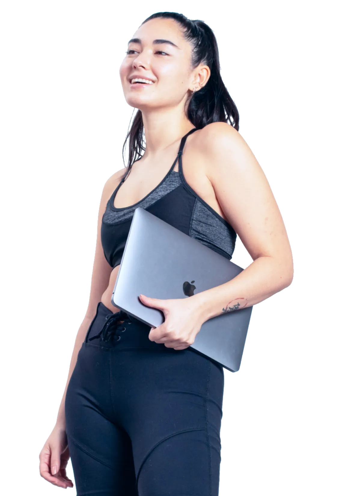 Woman in athletic clothes holding laptop